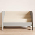 Grey modern low bookcase, for stacking books with the cover facing forward.