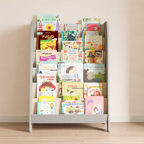 A gray Montessori bookcase for children. It has six shelves on which books are arranged with the cover facing forward.
