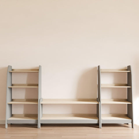 Grey nursery storage furniture. Two tall bookcases and one low bookcase.