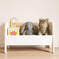 White wooden toy chest on legs for storing teddy bears, blocks and all toys. 