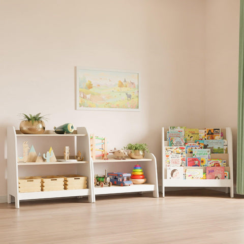 Set of three pieces of furniture for children's room: low white bookcase, toy storage, and Montessori bookshelf with four shelves filled with books stacked forward. 