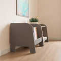 A set of gray low furniture for storage in the nursery.