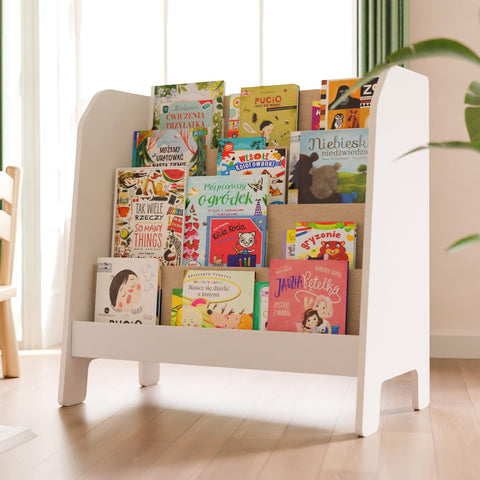 Modern white front facing bookshlef with four shelves on which stand children's books arranged with their covers facing forward.