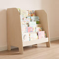 Modern wooden montessori style bookshelf, filled with books stacked with their covers facing forward.