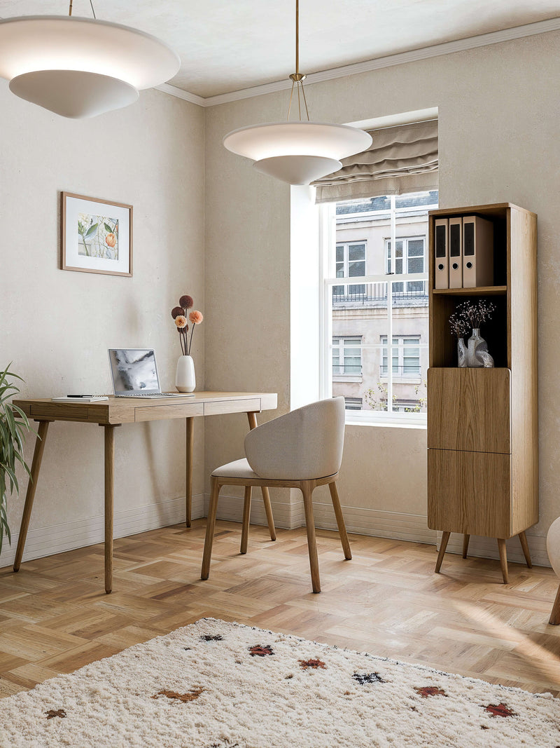 Modern oak home office furniture set with a minimalist desk and tall storage cabinet near a window