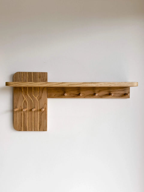 Front view of the empty Wall-Mounted Oak Coat Rack with Shelf. The minimalist design highlights the natural wood grain, 9 functional hooks, and the decorative engraved panel without any accessories.